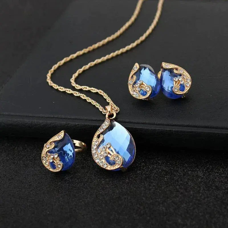 Parure collier et boucles d'oreilles or et cristaux bleus