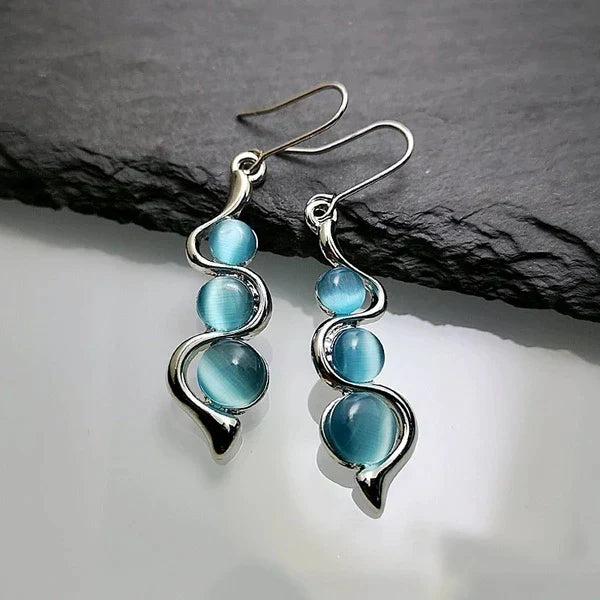 Boucles d'oreilles pendantes avec cristal bleu